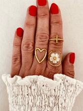 Load image into Gallery viewer, Fall in love with the effortless charm of this stainless steel hollow heart ring — a minimalistic statement piece with a romantic twist. Featuring a sleek open design and a delicate heart-shaped cutout, this ring blends Western-inspired style with modern simplicity. Available in both polished silver and radiant gold finishes, it's the perfect accessory for adding a subtle touch of elegance to your everyday look or party outfit. Durable, waterproof, and endlessly versatile, it also makes a thoughtful gift th