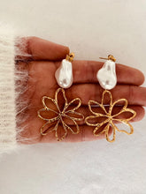 Load image into Gallery viewer, Turn heads with these romantic stainless steel and acrylic flower pearl earrings. Featuring an eye-catching, irregular artificial pearl as the focal point, these statement earrings are complemented by delicate flower contours that gracefully dangle below. A perfect blend of elegance and charm, they add a bold yet feminine touch to any outfit.
