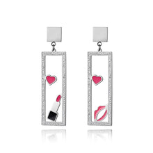 Load image into Gallery viewer, Add a playful touch to your look with these makeup elements pink lips & lipstick earrings. Crafted from rose gold color stainless steel, these charming earrings feature a fun design of pink lips and a lipstick adorned with sparkling rhinestones. Perfect for beauty lovers, they combine durability with a touch of glamour, making them a unique accessory for any outfit or a thoughtful gift for someone special.