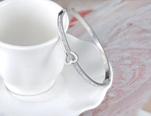 Load image into Gallery viewer, Celebrate timeless love with this stainless steel "Love Forever" rhinestone cuff bracelet. Elegantly designed with sparkling rhinestone accents and a sleek, durable finish, this bracelet exudes sophistication and romance. Perfect as a Valentine's Day gift or a meaningful accessory for everyday wear, it’s a beautiful reminder of everlasting affection. Durable and stylish, it’s a piece she’ll cherish forever.