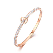 Load image into Gallery viewer, Celebrate timeless love with this stainless steel "Love Forever" rhinestone cuff bracelet. Elegantly designed with sparkling rhinestone accents and a sleek, durable finish, this bracelet exudes sophistication and romance. Perfect as a Valentine's Day gift or a meaningful accessory for everyday wear, it’s a beautiful reminder of everlasting affection. Durable and stylish, it’s a piece she’ll cherish forever.