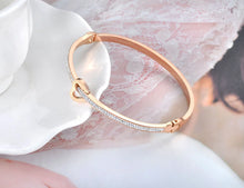 Load image into Gallery viewer, Celebrate timeless love with this stainless steel "Love Forever" rhinestone cuff bracelet. Elegantly designed with sparkling rhinestone accents and a sleek, durable finish, this bracelet exudes sophistication and romance. Perfect as a Valentine's Day gift or a meaningful accessory for everyday wear, it’s a beautiful reminder of everlasting affection. Durable and stylish, it’s a piece she’ll cherish forever.