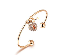 Load image into Gallery viewer, Unlock elegance with this stunning rose gold plated key and lock charm bangle. Beautifully crafted, this bracelet features a delicate key and lock charm adorned with sparkling cubic zirconia stones, adding a touch of glamour to any outfit. The sleek, rose gold finish brings warmth and sophistication, making it a perfect accessory for both casual wear and special occasions.
