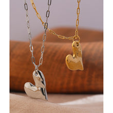 Load image into Gallery viewer, This simple stainless steel necklace comes in a gold and silver colour. It is adorned with a nice and delicate pendant in a shape of a heart. Irregular heart shape and its rugged surface gives this necklace a special touch. The necklace can be combined for any evening as well as for daily outfits. It has lobster clasp and adjustable chain.