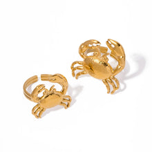 Load image into Gallery viewer, This stunning gold-colored stainless steel ring features a bold, eye-catching crab design that takes center stage, making it a striking statement piece. Perfect for adding a touch of coastal flair to your summer wardrobe, it also shines as a unique accessory for special occasions. The adjustable design ensures a comfortable fit, making it an ideal gift that’s both stylish and versatile.