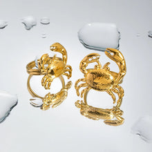 Load image into Gallery viewer, This stunning gold-colored stainless steel ring features a bold, eye-catching crab design that takes center stage, making it a striking statement piece. Perfect for adding a touch of coastal flair to your summer wardrobe, it also shines as a unique accessory for special occasions. The adjustable design ensures a comfortable fit, making it an ideal gift that’s both stylish and versatile.