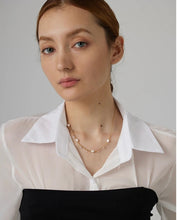 Load image into Gallery viewer, This romantic 18K gold plated stainless steel necklace comes in a gold colour. It is made as a combination of chain and natural freshwater pearls. The necklace is additionally adorned with little cubic zirconia that are attached to the chain. The necklace is perfect for spicing up your daily or evening outfit. It has lobster clasp and adjustable length.