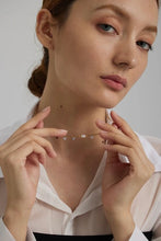 Load image into Gallery viewer, This romantic 18K gold plated stainless steel necklace comes in a gold colour. It is made as a combination of chain and natural freshwater pearls. The necklace is additionally adorned with little cubic zirconia that are attached to the chain. The necklace is perfect for spicing up your daily or evening outfit. It has lobster clasp and adjustable length.