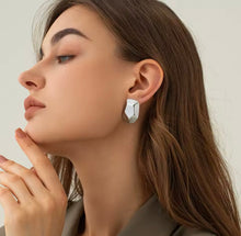 Load image into Gallery viewer, Elevate your style with these stainless steel striped polygon earrings, a perfect blend of minimalist design and modern texture. Featuring a sleek geometric shape with striped detailing, these earrings add a touch of sophistication to any outfit. Crafted from durable stainless steel, they offer a lightweight, tarnish-resistant finish that's perfect for everyday wear or special occasions. Trendy yet timeless, these earrings are a must-have for any jewelry collection.