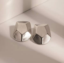 Load image into Gallery viewer, Elevate your style with these stainless steel striped polygon earrings, a perfect blend of minimalist design and modern texture. Featuring a sleek geometric shape with striped detailing, these earrings add a touch of sophistication to any outfit. Crafted from durable stainless steel, they offer a lightweight, tarnish-resistant finish that's perfect for everyday wear or special occasions. Trendy yet timeless, these earrings are a must-have for any jewelry collection.