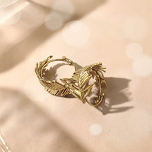 Load image into Gallery viewer, Embrace nature-inspired elegance with this stunning irregular leaf stainless steel ring, designed to make a bold yet refined statement. The ring's unique, asymmetrical leaf design creates an eye-catching, chic look that's perfect for the modern woman who loves to stand out. Crafted from durable, waterproof stainless steel, this trendy piece effortlessly blends creativity with everyday wear. Whether you're styling it for casual outings or adding flair to a more polished ensemble, this ring is the perfect acc