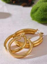 Load image into Gallery viewer, Elevate your style with these minimalistic big hollow hoop earrings, crafted from anti-allergic 316L stainless steel for lasting comfort and durability. Their sleek, round design offers a modern and trendy touch, perfect for adding effortless elegance to any outfit. Lightweight and versatile, these simple yet bold earrings are a must-have accessory for everyday wear or special occasions.