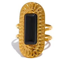 Load image into Gallery viewer, Make a statement with this striking square geometric open ring, featuring a bold, big stone available in four captivating colors: black, red, white, and green. Each stone is beautifully framed by a notched gold edge, adding texture and a luxurious touch to this modern design. Crafted from durable stainless steel and finished with high-quality gold plating, this wide, adjustable ring combines elegance with a contemporary twist, offering a perfect fit and lasting shine.