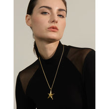 Load image into Gallery viewer, Elevate your summer style with this stunning statement necklace, available in both silver and gold tones. Expertly crafted from durable stainless steel with a luxurious gold plating, this piece features a long, intricate wheat chain that adds a touch of sophistication. The showstopper is the bold starfish pendant, beautifully embellished with a carved spiral detail, evoking the charm of seaside adventures. Complete with a secure lobster clasp and an adjustable length