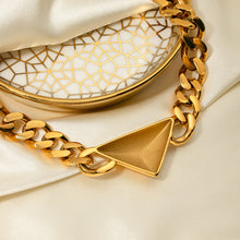 Load image into Gallery viewer, Make a bold yet understated statement with this luxury stainless steel Cuban chain geometric triangle necklace. Featuring a sleek triangle pendant paired with a classic Cuban chain, this unisex piece blends modern design with timeless appeal. Crafted from durable stainless steel, it offers a stylish, tarnish-resistant finish perfect for everyday wear or special occasions.
