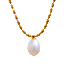 Load image into Gallery viewer, Elevate your style with this stunning gold-colored stainless steel necklace, featuring a uniquely patterned chain that exudes sophistication. Accentuated by a natural freshwater pearl pendant, it’s the perfect accessory for adding a touch of elegance to any glamorous occasion. Designed with both beauty and comfort in mind, it includes a secure lobster clasp and an adjustable chain for a customizable fit. Add this timeless piece to your collection for a refined look that complements any outfit.