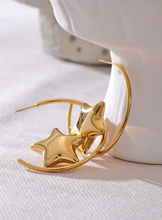 Load image into Gallery viewer, Enhance your style with these trendy stainless steel round star huggie earrings, available in sleek silver and radiant gold. Designed for modern women, their minimalist star charm adds a touch of elegance to any look. Crafted from anti-allergic stainless steel, they ensure comfort and durability, making them perfect for everyday wear. Whether as a thoughtful gift or a chic addition to your jewelry collection, these versatile earrings blend fashion and sophistication effortlessly.
