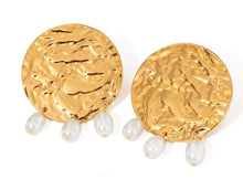 Load image into Gallery viewer, These sophisticated earrings are crafted from stainless steel with a luxurious gold finish. Designed in an elegant circular shape with a hammered texture, they feature three delicate artificial pearls gracefully hanging from each hoop. Perfect for elevating any evening ensemble, these earrings add a touch of timeless charm to special occasions. Secure and comfortable with stud fastenings, they are a versatile addition to your jewelry collection, combining classic style with modern elegance.