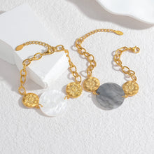 Load image into Gallery viewer, Embrace effortless elegance with this stylish bracelet, featuring a radiant sun pendant paired with a shell disc in your choice of white or black. Crafted from 18K gold-plated stainless steel, this waterproof piece is both durable and chic, making it perfect for daily wear or special occasions. A timeless accessory and a thoughtful gift for any jewelry lover.