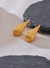 Load image into Gallery viewer, Add a touch of elegance to your look with these fashion stainless steel teardrop stud earrings. Featuring a sleek water drop design and a modern metal texture, these earrings are both trendy and timeless. Made from anti-allergic stainless steel, they offer comfort and durability, perfect for sensitive ears. Whether for everyday wear or a special occasion, these versatile earrings make a stylish addition to any jewelry collection and a thoughtful gift for someone special.