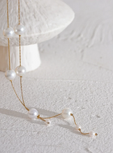 Load image into Gallery viewer, This elegant necklace features a delicate stainless steel chain adorned with imitation pearl beads, spaced gracefully along its length for a refined, charming look. The short, lightweight design is enhanced by a hanging chain detail, adding a touch of sophistication that’s perfect for galas, evening events, or daily wear.