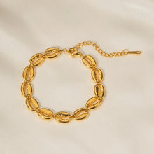 Load image into Gallery viewer, This exquisite stainless steel hollow shell bracelet in radiant 18K gold color is a beautiful blend of elegance and nature-inspired design. Featuring a delicate line of intricately crafted hollow shells, this bracelet is PVD plated for extra durability and a luxurious finish. Its waterproof quality makes it perfect for everyday wear, adding a touch of timeless charm to any outfit.