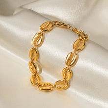 Load image into Gallery viewer, This exquisite stainless steel hollow shell bracelet in radiant 18K gold color is a beautiful blend of elegance and nature-inspired design. Featuring a delicate line of intricately crafted hollow shells, this bracelet is PVD plated for extra durability and a luxurious finish. Its waterproof quality makes it perfect for everyday wear, adding a touch of timeless charm to any outfit.
