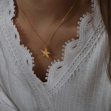 Load image into Gallery viewer, Make a bold statement with this edgy stainless steel star pendant necklace, designed for the modern woman with a punk-inspired aesthetic. Gold-plated for a sleek and stylish finish, this necklace exudes confidence and individuality. The striking star pendant adds a touch of celestial charm, making it the perfect accessory to elevate any look. Whether you're dressing up for a night out or adding a rebellious flair to your everyday style, this necklace is a versatile and eye-catching piece.