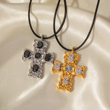 Load image into Gallery viewer, This glam rock necklace is made of stainless steel pendant which is hanging on a black wax rope. The beautiful cross pendant comes in two colours: gold and silver. It has irregular surface which is additionally adorned with 5 big cubic zirconia. It is a perfect piece for any daily occasion as well a great gift for your beloved friend. The necklace has lobster clasp and adjustable chain.