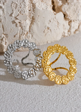 Load image into Gallery viewer, This bold stainless steel ring features a large, open round design crafted from interlocking hammered circles, creating a unique and eye-catching look. Its hollow, hyperbolic shape gives it a personalized, vintage-inspired appeal, perfect for adding a stylish, edgy touch to any outfit. With its trendy, textured metal and artistic detail, this ring is a standout piece for those who love statement jewelry that exudes individuality and modern charm.