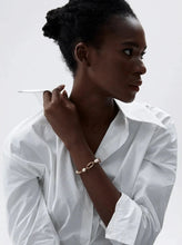 Load image into Gallery viewer, This elegant bracelet combines high-grade natural freshwater pearls with a modern, 18K gold plated metal chain for a trendy, stylish look. Featuring two contrasting chains and a toggle clasp, it strikes a beautiful balance between classic sophistication and contemporary flair. This eye-catching piece makes a perfect gift and elevates any outfit, whether for everyday wear or special occasions.