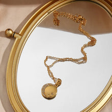 Load image into Gallery viewer, Stainless steel gold plated necklace is made of an elegant and thin chain. There is a round pendant which is adorned with a moon and a star. Both, the moon and the star are made of transparent cubic zirconia. This necklace is a perfect piece for an elegant occasion outfit. It has lobster clasp and adjustable length.