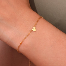 Load image into Gallery viewer, Embrace timeless elegance with this minimalist three heart O-Chain bracelet, crafted from premium stainless steel for a sleek and durable finish. Featuring a delicate chain adorned with three romantic heart charms, this bracelet adds a touch of luxury and femininity to any look. Perfect for everyday wear or special occasions, it’s a versatile and stylish accessory for any modern woman.