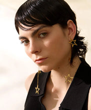 Load image into Gallery viewer, Shine bright with these fashion star long drop dangle earrings, a dazzling addition to any jewelry collection. Adorned with two larger star contours and two smaller star charms, these earrings are beautifully crafted from stainless steel and plated in 18K gold for a radiant, luxurious finish. Their elongated design offers graceful movement and a striking silhouette, perfect for adding a touch of glamour to any outfit.
