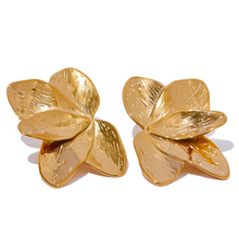 Load image into Gallery viewer, These bold flower stud earrings, crafted from waterproof stainless steel in a radiant gold color, feature large, eye-catching petals that make a high-quality fashion statement. Their oversized floral design offers a touch of elegance and femininity, perfect for adding flair to any outfit. Durable and beautifully crafted, these earrings are ideal for women who appreciate stylish, standout accessories.