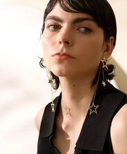 Load image into Gallery viewer, Shine bright with these fashion star long drop dangle earrings, a dazzling addition to any jewelry collection. Adorned with two larger star contours and two smaller star charms, these earrings are beautifully crafted from stainless steel and plated in 18K gold for a radiant, luxurious finish. Their elongated design offers graceful movement and a striking silhouette, perfect for adding a touch of glamour to any outfit.
