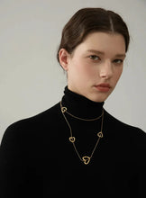 Load image into Gallery viewer, Add a touch of romance to your look with this stunning 85cm stainless steel heart contour charm necklace, available in both silver and gold finishes. Elegantly designed, this long chest chain features delicate heart-shaped charms spread along the length of the chain, creating a subtle yet captivating statement of love. Crafted from durable, waterproof stainless steel, this piece ensures lasting shine and beauty, making it perfect for both everyday wear and special occasions.