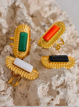 Load image into Gallery viewer, Make a statement with this striking square geometric open ring, featuring a bold, big stone available in four captivating colors: black, red, white, and green. Each stone is beautifully framed by a notched gold edge, adding texture and a luxurious touch to this modern design. Crafted from durable stainless steel and finished with high-quality gold plating, this wide, adjustable ring combines elegance with a contemporary twist, offering a perfect fit and lasting shine.