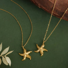 Load image into Gallery viewer, Make a bold statement with this edgy stainless steel star pendant necklace, designed for the modern woman with a punk-inspired aesthetic. Gold-plated for a sleek and stylish finish, this necklace exudes confidence and individuality. The striking star pendant adds a touch of celestial charm, making it the perfect accessory to elevate any look. Whether you're dressing up for a night out or adding a rebellious flair to your everyday style, this necklace is a versatile and eye-catching piece.