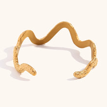 Load image into Gallery viewer, This striking open bangle bracelet features a unique hammered pattern and a sleek snake design, crafted from waterproof stainless steel for durability and style. Its bold, textured look adds an edgy yet elegant touch to any outfit, making it a perfect statement piece for fashion-forward women.