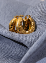 Load image into Gallery viewer, These elegant, chunky hoop earrings are crafted from durable stainless steel with a radiant gold finish, designed to bring a touch of sophistication to everyday looks. Featuring a unique crumpled texture along the edges, they add a modern twist to the classic hoop, making them a standout piece for any occasion. Lightweight yet bold, these hollow hoops are perfect for daily wear and make a thoughtful gift for any woman who appreciates stylish, personalized jewelry.