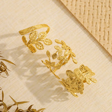 Load image into Gallery viewer, Add a touch of nature’s elegance to your look with this exquisite stainless steel metal plants ring. Featuring a beautifully irregular texture and 18K gold plating, this ring combines organic, leaf-inspired design with a modern, luxurious twist. The intricate metalwork captures the beauty of nature while remaining trendy and wearable for any occasion. Waterproof and crafted for durability, this statement piece is perfect for those who appreciate bold style with a timeless, sophisticated charm. A must-have f