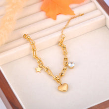 Load image into Gallery viewer, Add a touch of elegance and charm to your look with this stainless steel cubic zirconia crystal charm bracelet. Plated in radiant 18K gold, this delicate chain bracelet features a trio of enchanting charms—a sparkling zircon, a shining star, and a timeless heart. Perfect for everyday wear or special occasions, this bracelet combines durability and style, making it a versatile addition to any jewelry collection or a thoughtful gift for someone special.