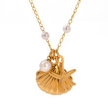 Load image into Gallery viewer, Enhance your summer style with this exquisite stainless steel necklace, featuring a delicate chain adorned with lustrous pearl accents. The necklace showcases three stunning pendants: a graceful pearl, a charming starfish, and a detailed seashell, each capturing the essence of the ocean. Whether you're dressing up for a special evening or adding a touch of elegance to your everyday look, this necklace is the perfect accessory. Finished with a luxurious gold plating, it features a secure lobster clasp and an
