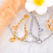 Load image into Gallery viewer, Add a touch of elegance and charm to your look with this stainless steel cubic zirconia crystal charm bracelet. Plated in radiant 18K gold, this delicate chain bracelet features a trio of enchanting charms—a sparkling zircon, a shining star, and a timeless heart. Perfect for everyday wear or special occasions, this bracelet combines durability and style, making it a versatile addition to any jewelry collection or a thoughtful gift for someone special.