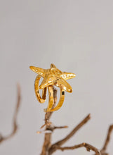 Load image into Gallery viewer, Embrace the essence of summer with this stainless steel starfish open ring, a playful and elegant accessory perfect for your holiday look. 18K gold plated for a luxurious finish, this adjustable ring features a charming starfish design that brings a touch of the ocean to your style. Crafted for durability and comfort, it’s an ideal piece for those who love personalized, summer-inspired jewelry.