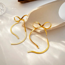 Load image into Gallery viewer, These long tassel bow earrings are a striking statement piece, featuring a graceful bowknot design with sleek flat snake chains that add a sense of fluid movement. Made from high-quality stainless steel, they are both durable and lightweight, offering a stylishly modern look with a hint of elegance.