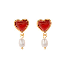 Load image into Gallery viewer, Embrace timeless romance with these stainless steel inlaid onyx heart shape freshwater pearl earrings. Featuring a stunning combination of glossy onyx hearts and delicate freshwater pearls, these earrings exude elegance and charm. Crafted from durable stainless steel, they offer a sophisticated, tarnish-resistant finish, making them perfect for any occasion. A thoughtful and stylish gift for someone special or a beautiful addition to your jewelry collection.