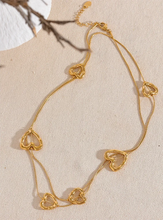Load image into Gallery viewer, Add a touch of romance to your look with this stunning 85cm stainless steel heart contour charm necklace, available in both silver and gold finishes. Elegantly designed, this long chest chain features delicate heart-shaped charms spread along the length of the chain, creating a subtle yet captivating statement of love. Crafted from durable, waterproof stainless steel, this piece ensures lasting shine and beauty, making it perfect for both everyday wear and special occasions.