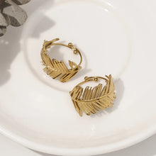 Load image into Gallery viewer, Embrace nature-inspired elegance with this stunning irregular leaf stainless steel ring, designed to make a bold yet refined statement. The ring's unique, asymmetrical leaf design creates an eye-catching, chic look that's perfect for the modern woman who loves to stand out. Crafted from durable, waterproof stainless steel, this trendy piece effortlessly blends creativity with everyday wear. Whether you're styling it for casual outings or adding flair to a more polished ensemble, this ring is the perfect acc